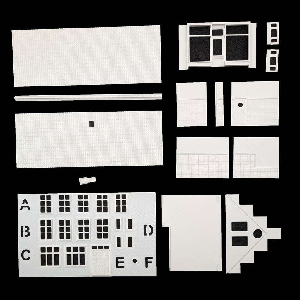 Übersicht der präzisen Einzelteile des Bausatzes: Fensterrahmen, Türen und Fassadenelemente für TT.
