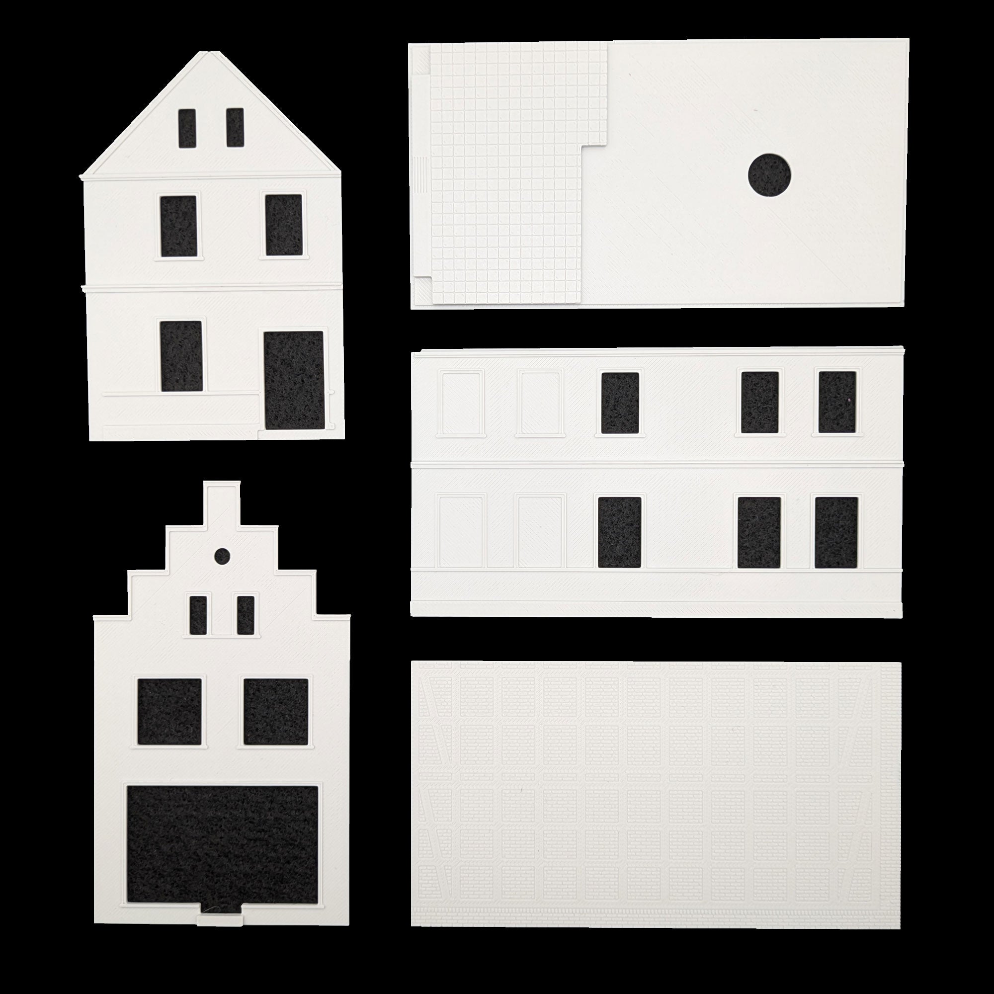 Set der Hauptwände und Giebelteile des Modellhaus-Bausatzes zur Montage.